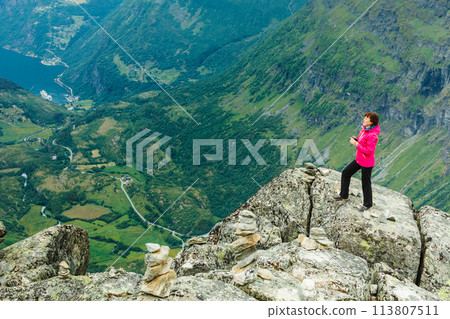 Tourist woman on Dalsnibba viewpoint Norway 113807511