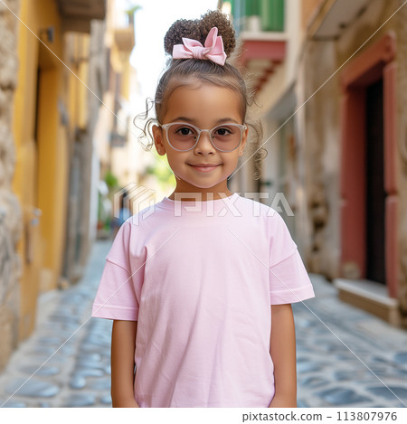 Cute little girl in pink dress posing on street. Pink Bella Canvas 3001T Kid Mockup. Cute little girl in pink dress posing on street. Pink Bella Canvas 3001T Kid Mockup. 113807976