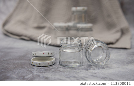 Small glass jars for sauce, jam on gray background . space for your text Small glass jars for sauce, jam on gray background . space for your text 113808011