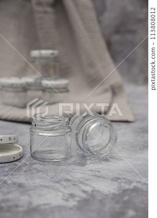 Small glass jars for sauce, jam on gray background . space for your text Small glass jars for sauce, jam on gray background . space for your text 113808012