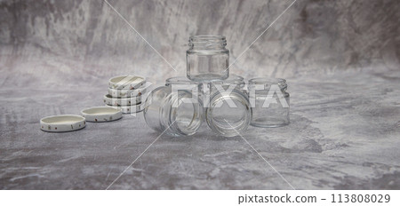 Small glass jars for sauce, jam on gray background . space for your text 113808029
