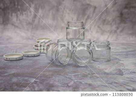 Small glass jars for sauce, jam on gray background . space for your text 113808030