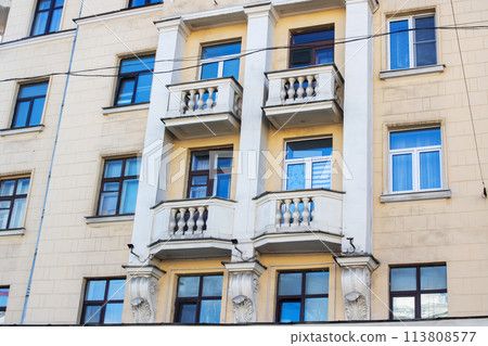 A property with azure windows and balconies, a fixture in the buildings facade A property with azure windows and balconies, a fixture in the buildings facade 113808577