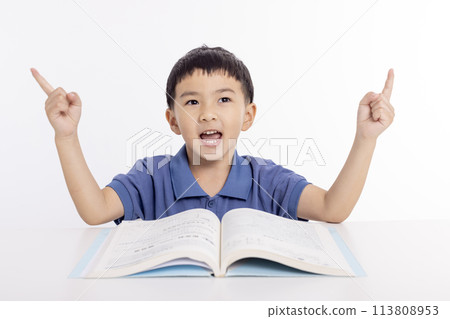 Excited asian child schoolboy studying  at home and hand pointing up 113808953