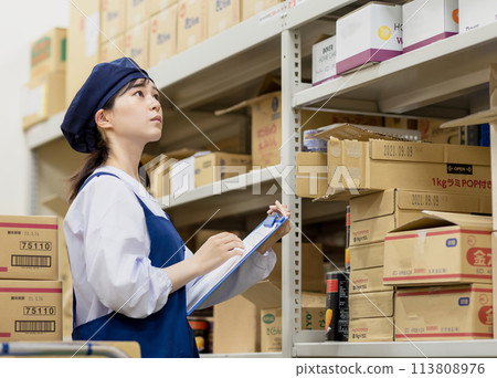 A woman working in a warehouse A woman working in a warehouse 113808976