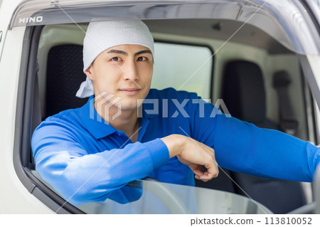 A young man driving a truck A young man driving a truck 113810052