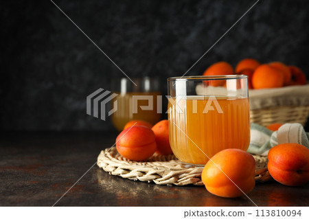 A glass of fresh apricot juice on a dark background A glass of fresh apricot juice on a dark background 113810094