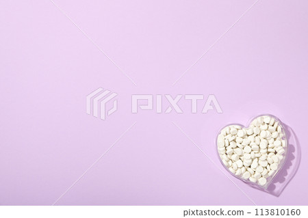 Hormonal pills for the heart, on a purple background. Hormonal pills for the heart, on a purple background. 113810160