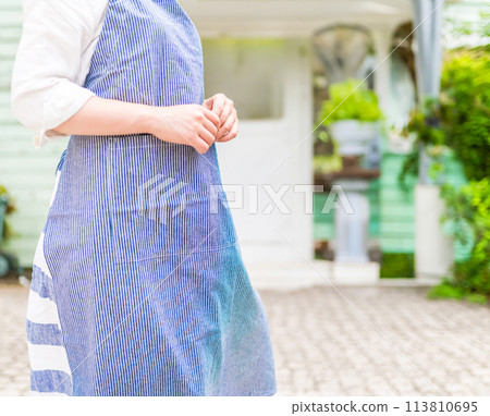 A woman wearing an apron A woman wearing an apron 113810695
