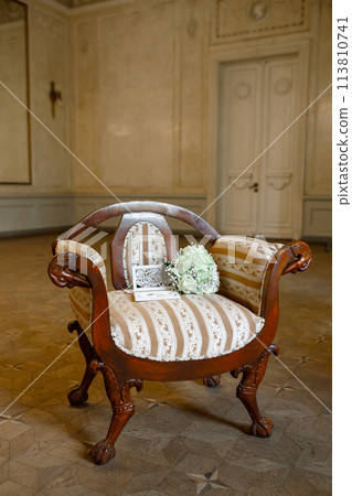 Wedding bouquet of white roses on a vintage armchair 113810741