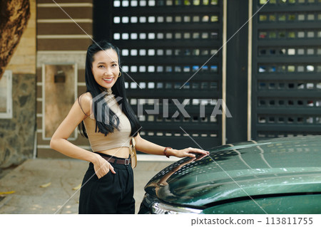 Portrait of happy Vietnamese woman standing next to her car 113811755