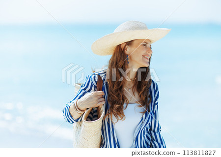 happy modern 40 years old woman on ocean coast 113811827