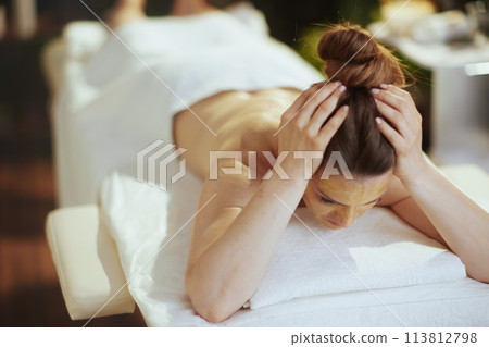 stressed woman in massage cabinet laying on massage table stressed woman in massage cabinet laying on massage table 113812798