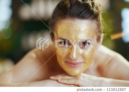 relaxed modern female in spa salon laying on massage table relaxed modern female in spa salon laying on massage table 113812807