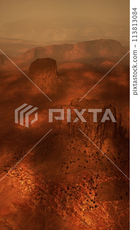 vast desert landscape with sand dunes, sparse vegetation, and a clear blue sky 113813084