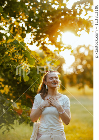 happy trendy 40 years old woman in white shirt 113813186