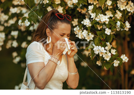 sad elegant woman in white shirt has allergy attack and sad elegant woman in white shirt has allergy attack and 113813190