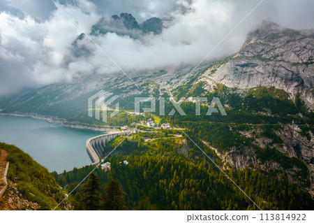 landscape with mountains, Fedaia lake, clouds and forest 113814922