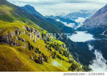 landscape with mountains, hills, Fedaia lake, clouds and rocks 113814943