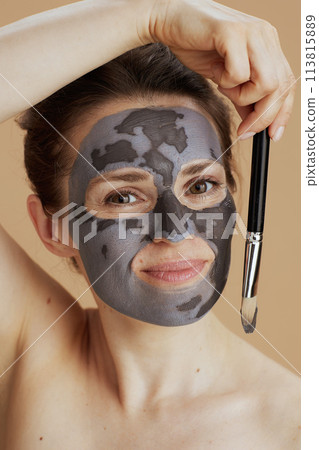 young 40 years old woman with brush and cosmetic mask 113815889