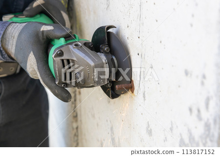 The foundation separator is being cut with a disc grinder. The foundation separator is being cut with a disc grinder. 113817152