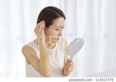 Middle-aged woman with hair problems 113817779