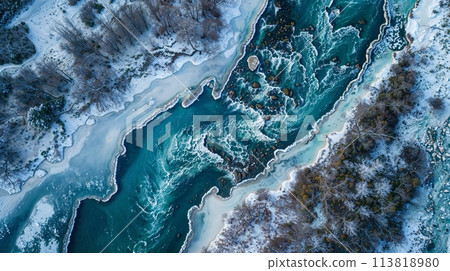 A river flowing through a snowy forest from an aerial view A river flowing through a snowy forest from an aerial view 113818980