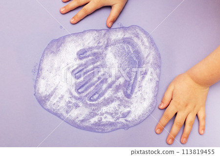 child playing with a slime at home. kid stretching colorful slime. DIY concept. child playing with a slime at home. kid stretching colorful slime. DIY concept. 113819455