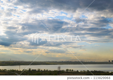 Beautiful cloudy scenery over the lake and the city at sunset at dusk 113820068