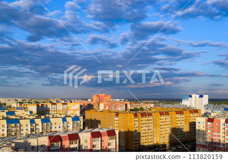 Top view of the city in the light of the sun under a cloudy sky at sunset Top view of the city in the light of the sun under a cloudy sky at sunset 113820159