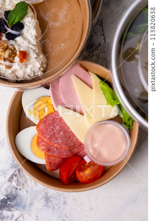 top view of a craft plate with breakfast close-up. Sausage, tomato, egg and cheese. 113820638