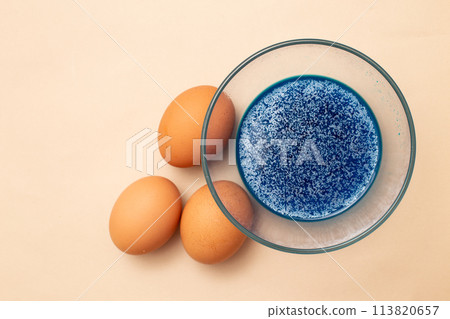 festive painted Easter eggs with colorful dyes on the table at home. 113820657