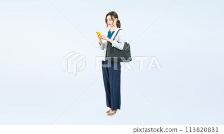 Full-body photo of a Caucasian female business person using a smartphone 113820831