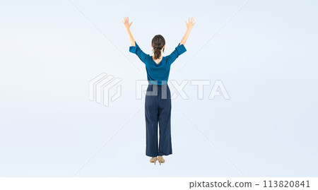 Full-body photo of a Caucasian woman's back showing her arms in the air 113820841