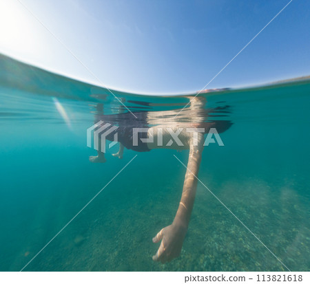Young male on holidays enjoy floating on a crystal clear water beach of Antalya Turkey. Man swimming with open arms. Relax and tranquility Young male on holidays enjoy floating on a crystal clear water beach of Antalya Turkey. Man swimming with open arms. Relax and tranquility 113821618
