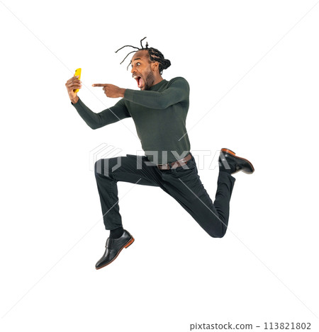 Black man jumping while looking at his smartphone. Full-body photo PNG with transparent background precisely cut out by hand. Black man jumping while looking at his smartphone. Full-body photo PNG with transparent background precisely cut out by hand. 113821802