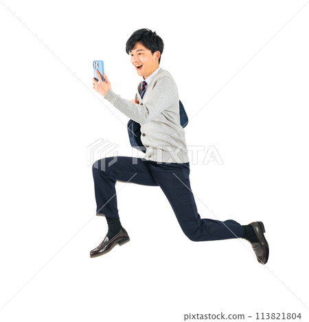 A male student in uniform jumping while looking at his smartphone. A transparent full-body photo PNG precisely cut by hand 113821804