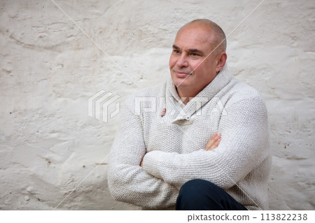 Handsome elderly man on a concrete wall background. 113822238