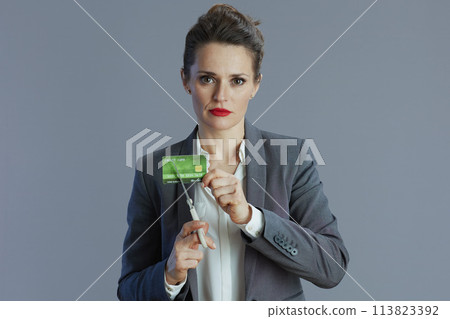 sad trendy 40 years old woman employee against gray background sad trendy 40 years old woman employee against gray background 113823392