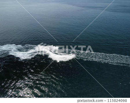 People are playing a jet ski in the sea, leaving abstract white footprints on the water. Aerial top view. Amazing nature background. Water color are beautifully vibrant. Fresh freedom. Adventure day. People are playing a jet ski in the sea, leaving abstract white footprints on the water. Aerial top view. Amazing nature background. Water color are beautifully vibrant. Fresh freedom. Adventure day. 113824098
