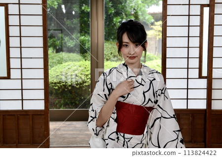 Portrait of a young woman wearing a yukata Portrait of a young woman wearing a yukata 113824422