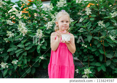 Child girl walks and have fun outdoor with cochlear implant on the head. Hearing aid and treatment concept. Copy space. Inclusion and people with disability 113824597