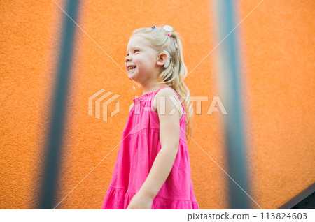 Child girl walks and have fun outdoor with cochlear implant on the head. Hearing aid and treatment concept. Copy space. Inclusion and people with disability Child girl walks and have fun outdoor with cochlear implant on the head. Hearing aid and treatment concept. Copy space. Inclusion and people with disability 113824603
