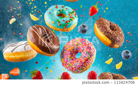 Colorful doughnuts in motion on blue background 113824706
