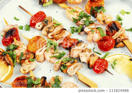 Seafood kebabs grilled on sticks. 113824986