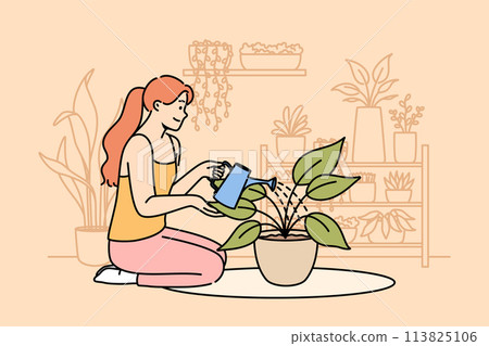 Woman florist grows houseplants to decorate own apartment, waters flower while sitting on floor 113825106