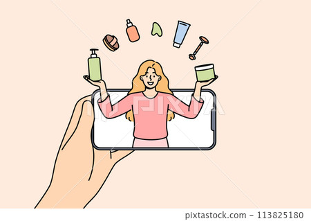 Woman beauty blogger juggles with cosmetics, looking out from phone, giving tips on applying makeup 113825180
