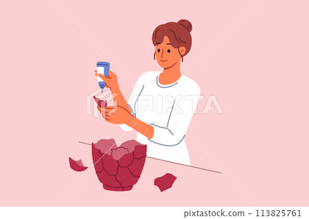 Woman restores old vase and uses glue to repair glass vessel that was damaged when it fell to ground 113825761