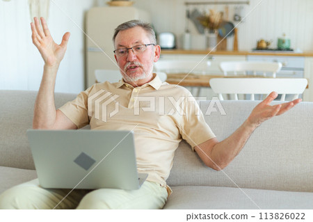 Happy middle aged senior man with laptop talk on video call with friends family. Mature old senior grandfather having fun talking with grown up children online. Older generation modern tech usage 113826022