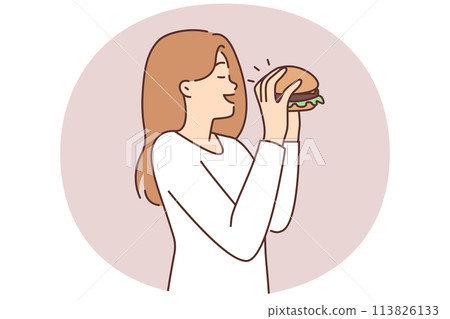 Happy woman eating hamburger 113826133